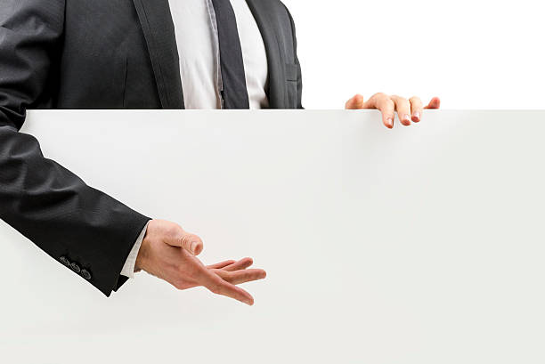 istock Businessman gesturing to a blank white board 482660823