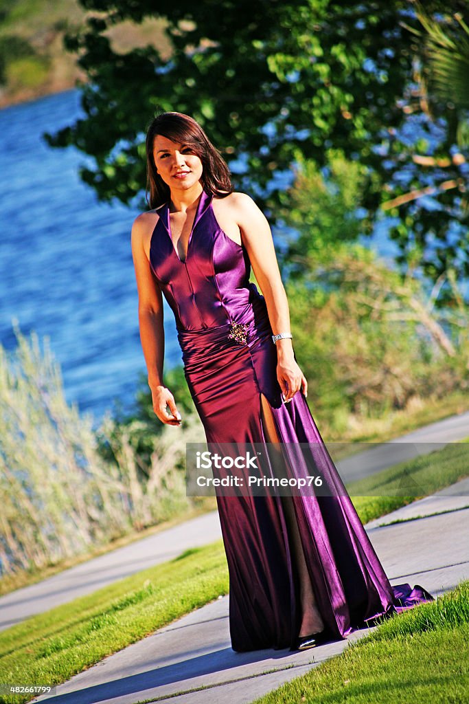 That Beautiful Hispanic Look Beautiful Hispanic woman in a formal dress walking with confidence, on a cement path, by the river. Adult Stock Photo