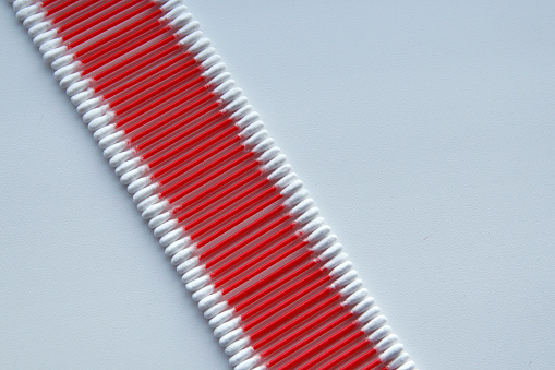 Red cotton swabs on a white background