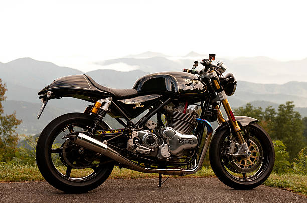 Norton Commando 961 SE #112 2014 Ashville, North Carolina, USA - July 16, 2015: A very Rare Norton 961 SE Motorcycle #112 of only 200 bikes in the world on the Blue Ridge Parkway, posing in front of fog filled mountains at 6:42am for a sunrise picture. Ashville, North Carolina, USA norton brand name stock pictures, royalty-free photos & images