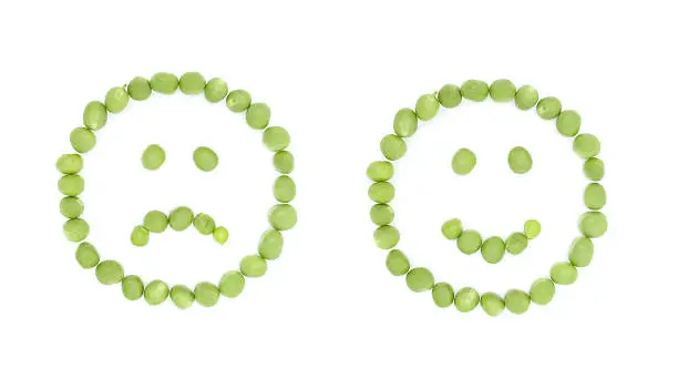 Photo of Cheerful and sad sign smile with green peas