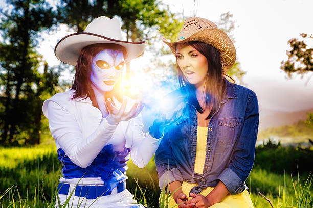 Young women in costumes of cowboys outdoors