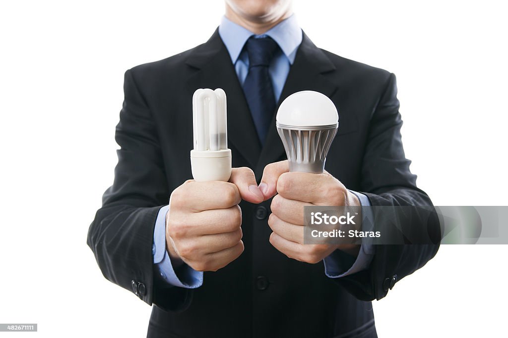 Businessman with fluorescent, LED lamps and incandescent Businessman with fluorescent and LED lamps and incandescent isolated on a white background Adult Stock Photo