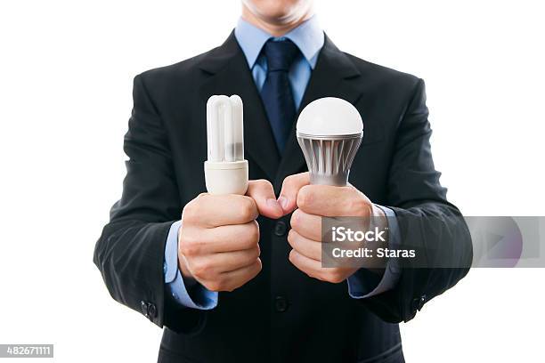 Businessman With Fluorescent Led Lamps And Incandescent Stock Photo - Download Image Now