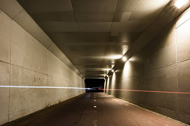 istock View of a cycle tunnel at night with light trails 482671606