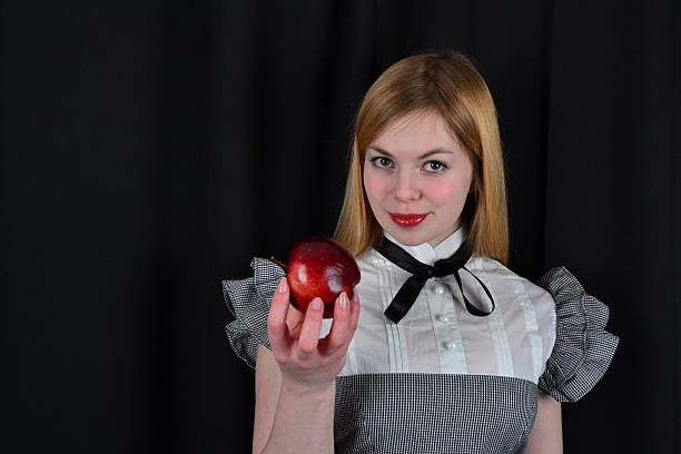 istock Blond woman with red apple 482672209