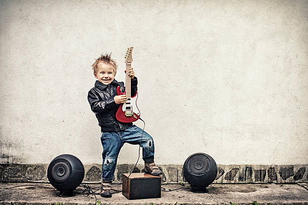 istock Little boy playing electric guitar 482673237