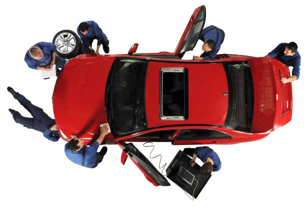 Manual workers working Manual workers working on a red car, isolated on white. car mechanic top view stock pictures, royalty-free photos & images