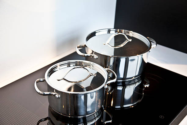 istock Stainless Steel Casserole On A Ceramic Stove 482674199