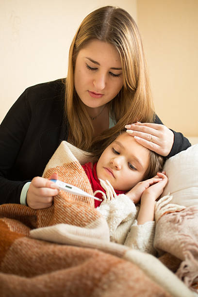 istock measuring sick daughter temperature with digital thermometer 482674950