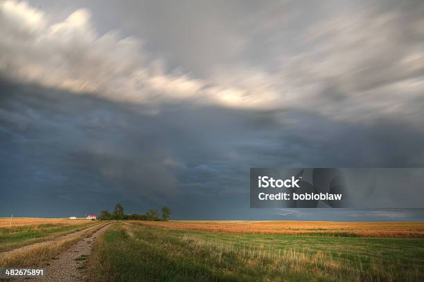 Storm Clouds Along A Saskatchewan Farm Road Stock Photo - Download Image Now - Canada, Farm, Horizontal