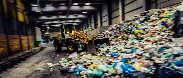istock Panoramic shot of the earth mover in the garbage dump 482676338