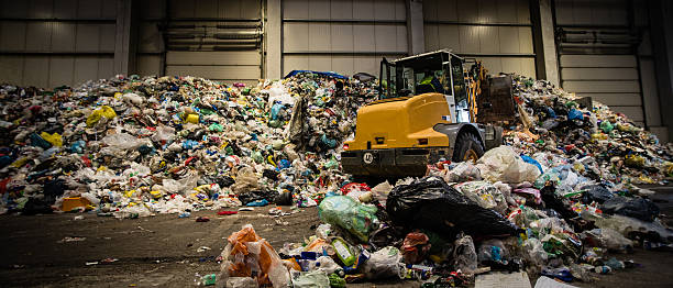 istock Panoramic shot of the earth mover in the garbage dump 482676340