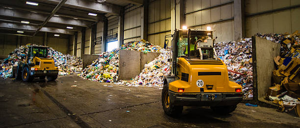 istock Panoramic shot of the earth movers in the garbage dump 482676342