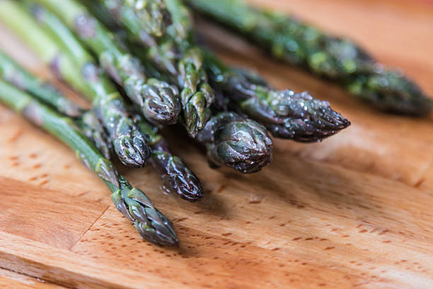 Wild asparagus Wild asparagus on wood lavagna stock pictures, royalty-free photos & images