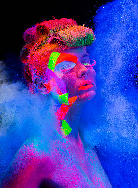 istock Women Portrait with Glowing makeup in black light 482676461