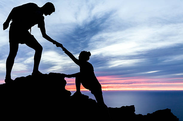 istock Man and woman hiking silhouette in mountains 482677611