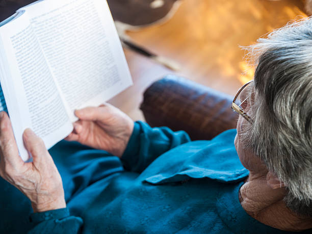 Senior lady reading a book stock photo