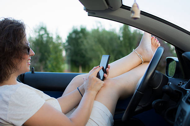 istock Young attractive girl in the car using mobile phone 482680496
