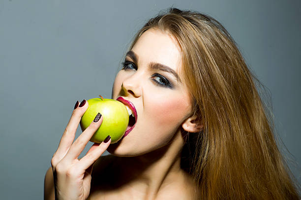 istock Sensual blonde girl with apple 482680518