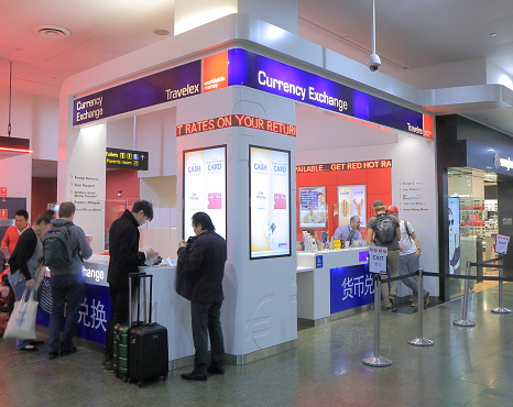 Melbourne Australia - June 18, 2015: People exchange money at Travelex Melbourne Airport in Melbourne Australia.