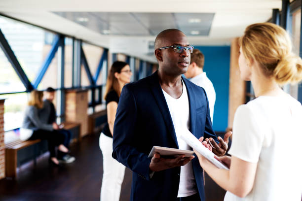 istock Black executive talking to white female colleague 482684622