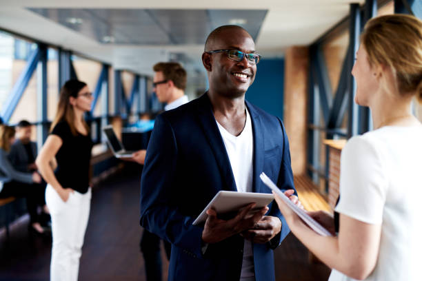 istock Black executive and white executive smiling at eachother 482684682