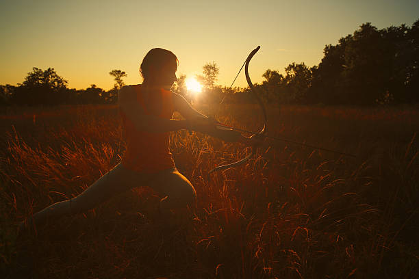 istock Female archer in the field at sunset 482685776