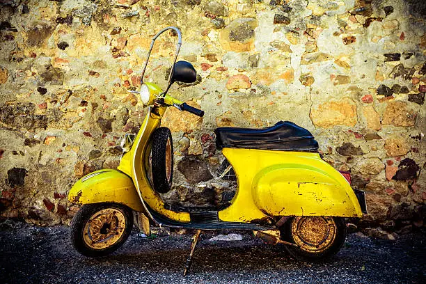 Italian urban scene with a Vespa, a very typical italian motorcycle