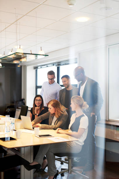 istock Group of executives gathered in conference room 482689036