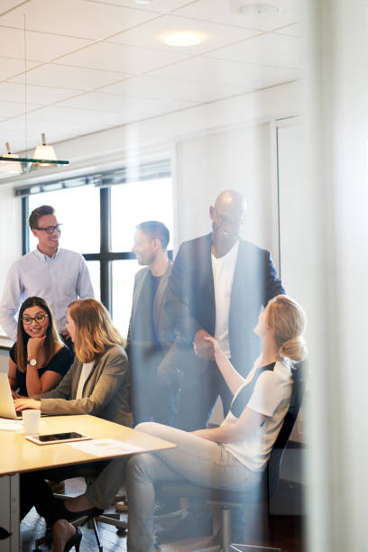 istock Group of executives gathered in conference room 482689042