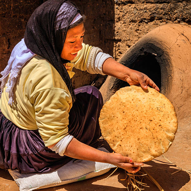 istock Moroccan woman baking bread - khubz 482689409