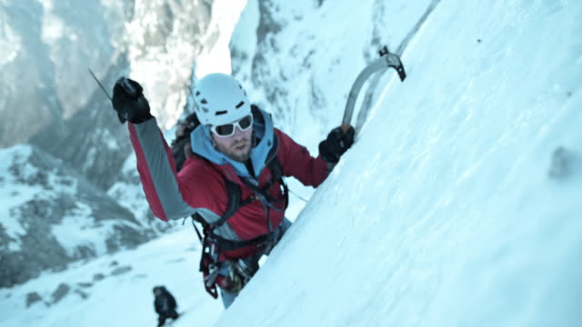 SLO MO winter climber using his ice axe