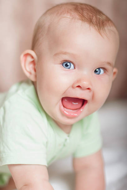 istock Sweet baby on the bed smiling 482689969