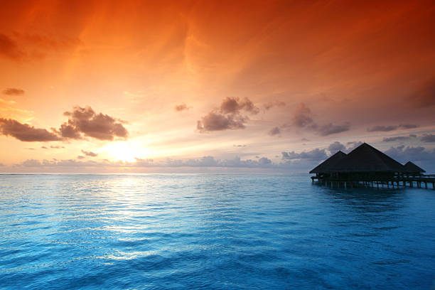 istock maldivian houses on sunrise 482690293