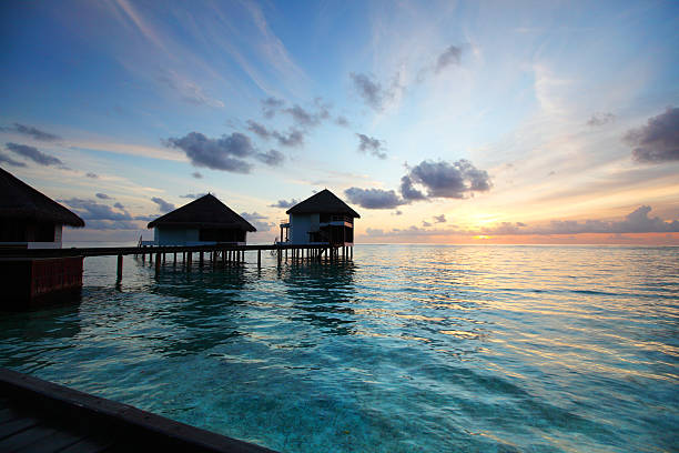 istock maldivian houses on sunrise 482690341
