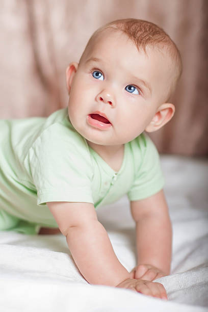 istock Sweet baby on the bed smiling 482690395