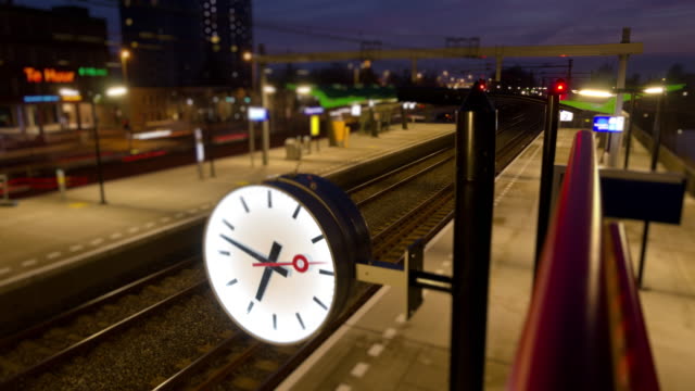 Clock in a small train station time lapse