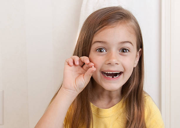 Look! I Lost My First Tooth! Overjoyed little girl because she just lost her first gap toothed photos stock pictures, royalty-free photos & images