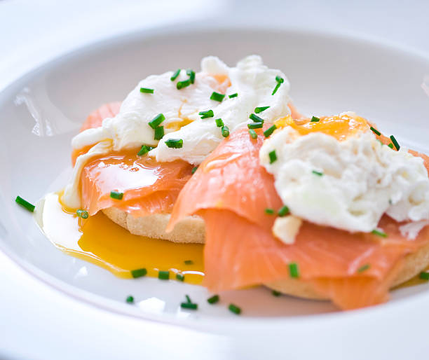 Eggs benedict with salmon and chives stock photo