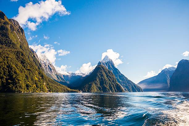 Milford Sound - New Zealand Mitre Peak in Milford sound on a clear calm day, taken from a tour ferry in the Sound. milford sound photos stock pictures, royalty-free photos & images
