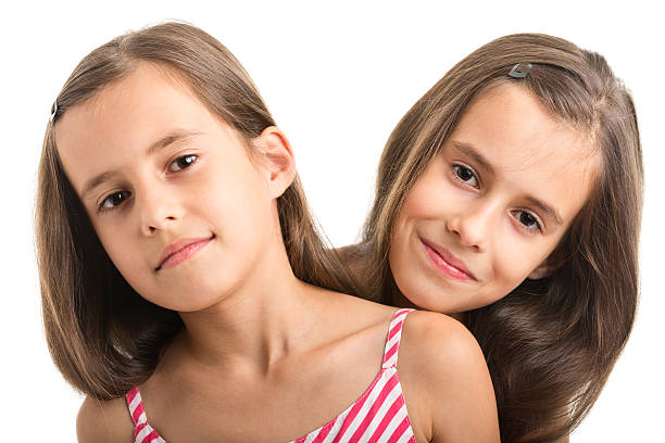 istock portrait of happy twins 482693133