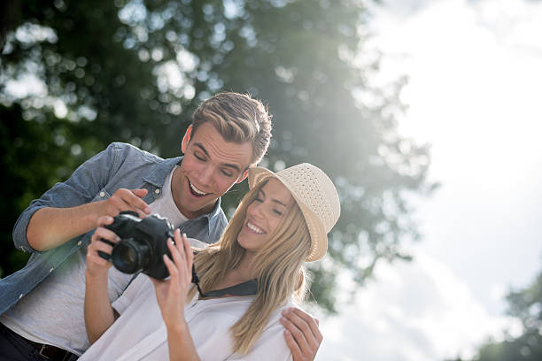 istock Couple having fun at the park taking pictures 482694224