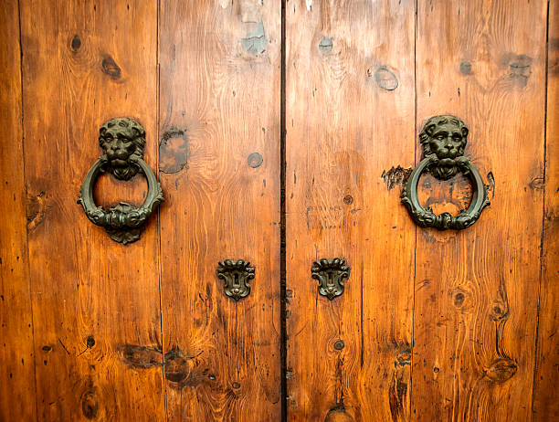 istock Large wooden doors with iron decorative lion head knockers 482694262