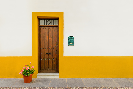 Entrance of a house with letterbox and flowers in Cordoba, Spain, Andalusia. 