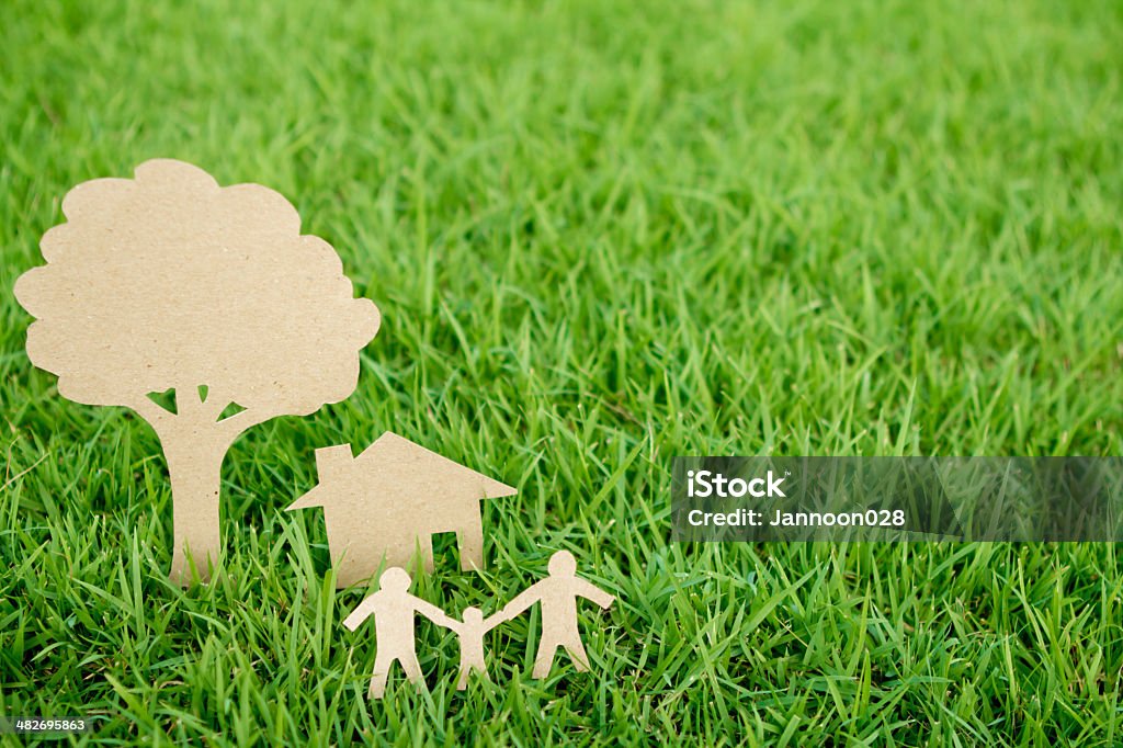 Paper cut of family with house Paper cut of family with house , tree and car on fresh spring green grass Built Structure Stock Photo