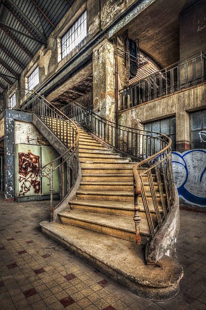 Imposing staircase inside the hall of an abandoned power plant stock photo