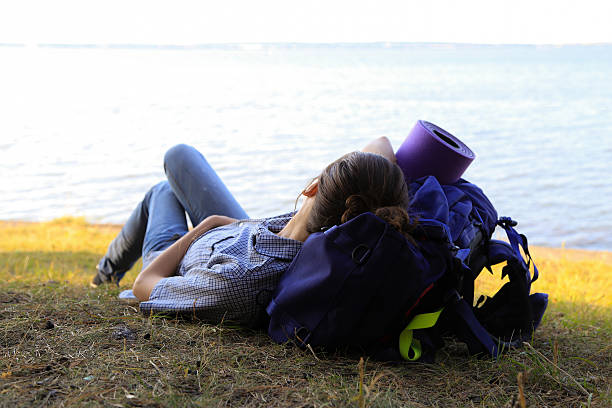 istock girl with a backpack lying looks into the distance 482701400