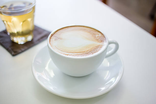 istock Hot Cappuccino Coffee cup on the wood table in shop 482704052
