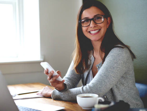 istock Woman smiling sitting at desk in home office. 482706448